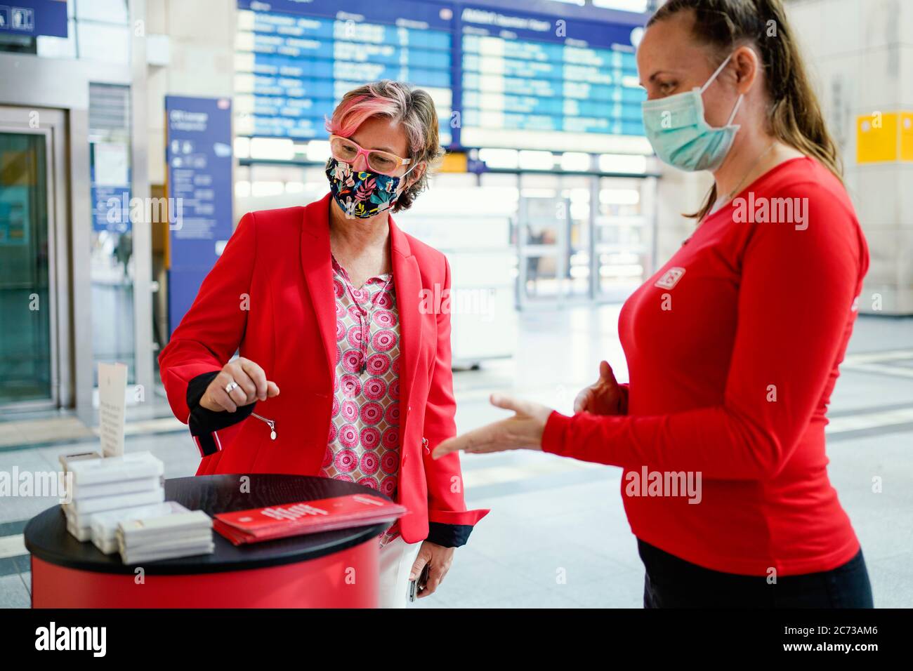 Mannheim, Germany. 09th July, 2020. Andrea Kadenbach (l), Head of Station Management Mannheim, talks to the employee of a promotion campaign at the main station. (to dpa: 'Only station manager rules over 146 stops') Credit: Uwe Anspach/dpa/Alamy Live News Stock Photo