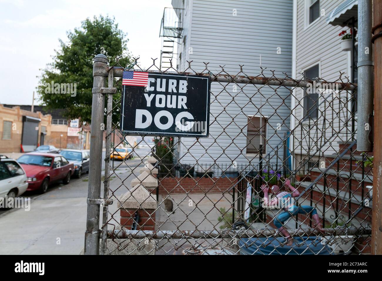 American flag on ‘Curb Your Dog’ sign. Stock Photo