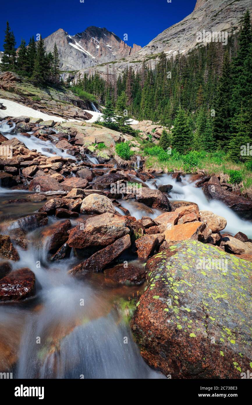 Ribbons Falls waterfall with McHenry's Peak in the background with blue ...