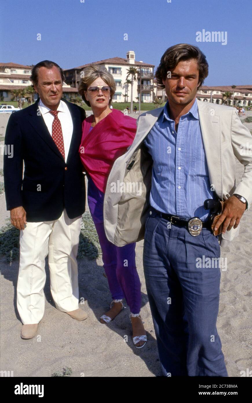 Actors Harry Hamlin, Rip Torn, and Ann Francis pose for a photo while filming on the movie Laguna Heat in the 1980s. Stock Photo