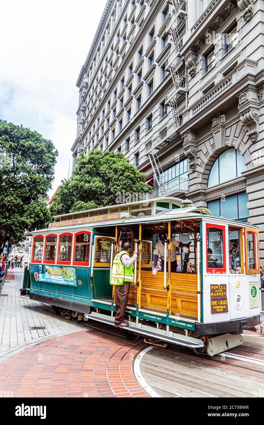San Francisco California,Powell Street,Hallidie Plaza,downtown street scene,transit system,historic cable car,icon,man powered turntable,gripman,condu Stock Photo