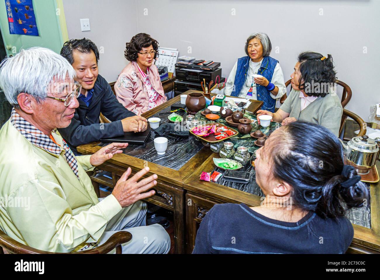 San Francisco California,Chinatown neighborhood,Grant Street,tearoom,tea house,cha guan,family families parent parents child children,Asian man men ma Stock Photo