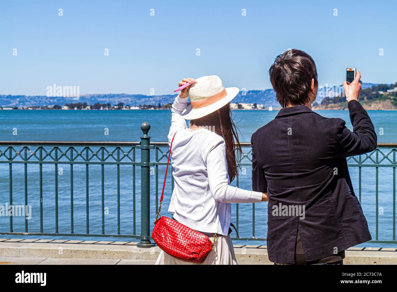 San Francisco California,The Embarcadero,San Francisco Bay water,Bay water Trail,public promenade,waterside recreation area,Asian Asians ethnic immigr Stock Photo