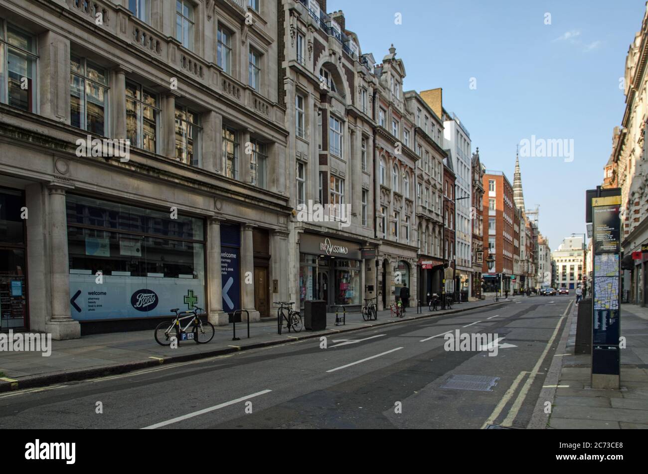 London, UK - April 24, 2020:  Shops and cafes on Little Portland Street in the Fitzrovia district of central London on a late Spring day. Stock Photo