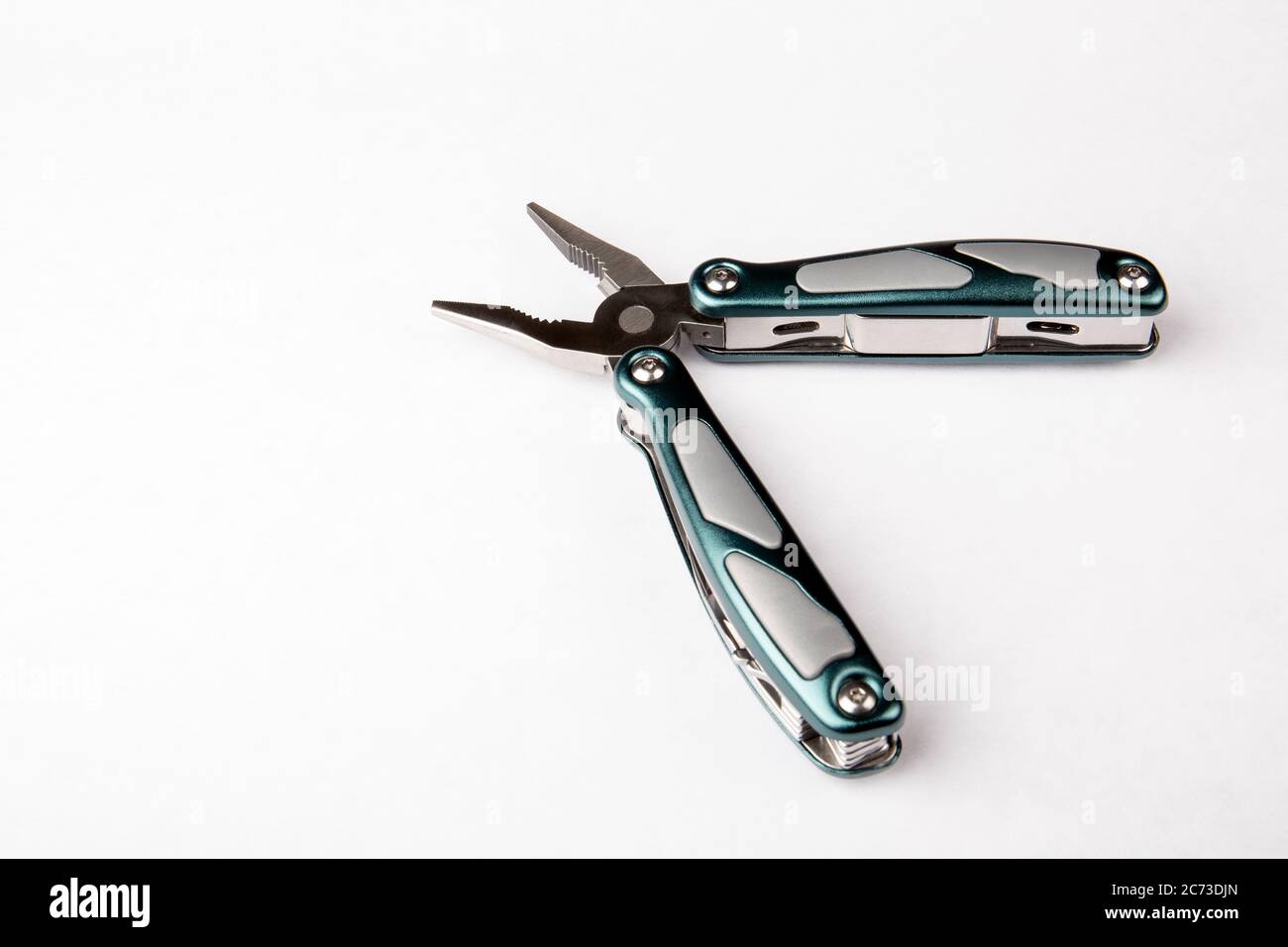 Multitool with pliers on white background. Top view. Tools for cutting, sawing, screwing, compressing and other. Stock Photo