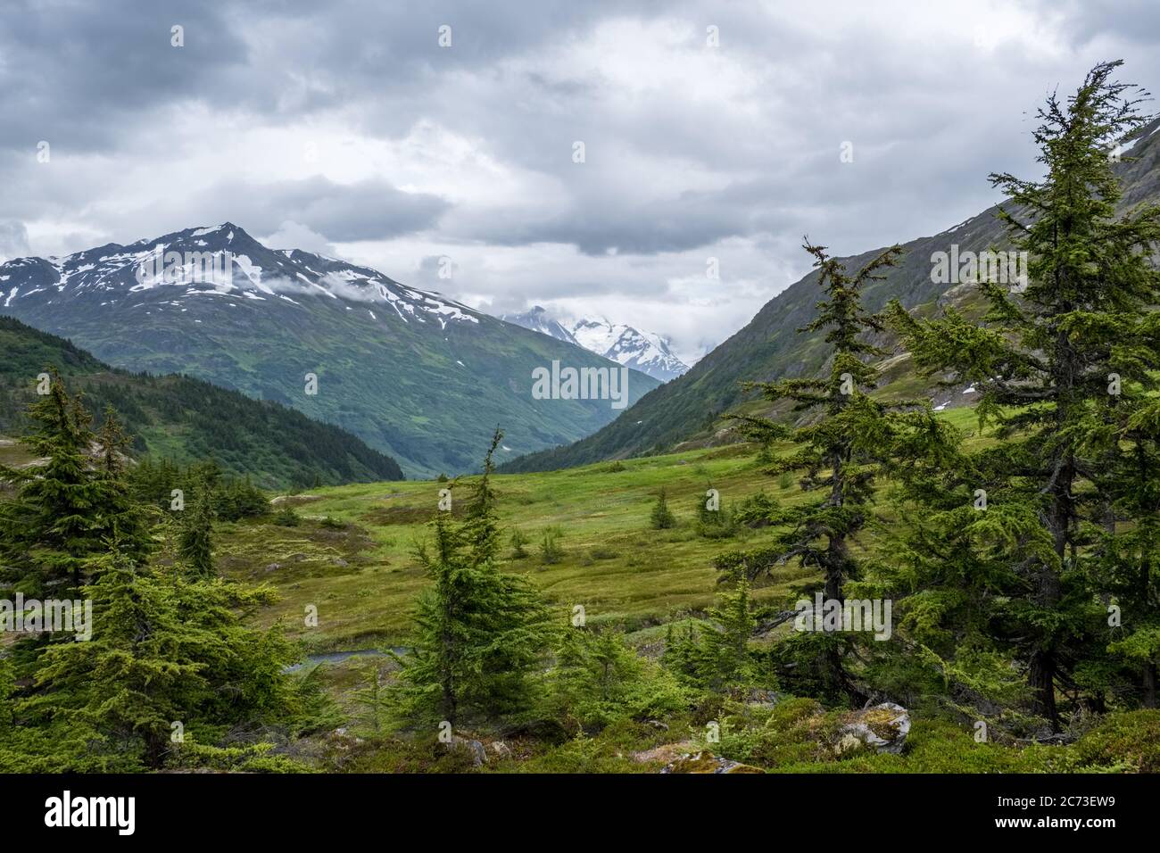 Brooding Blue Valley Gorgeous glacial valley with brooding mountain weather Stock Photo - Alamy
