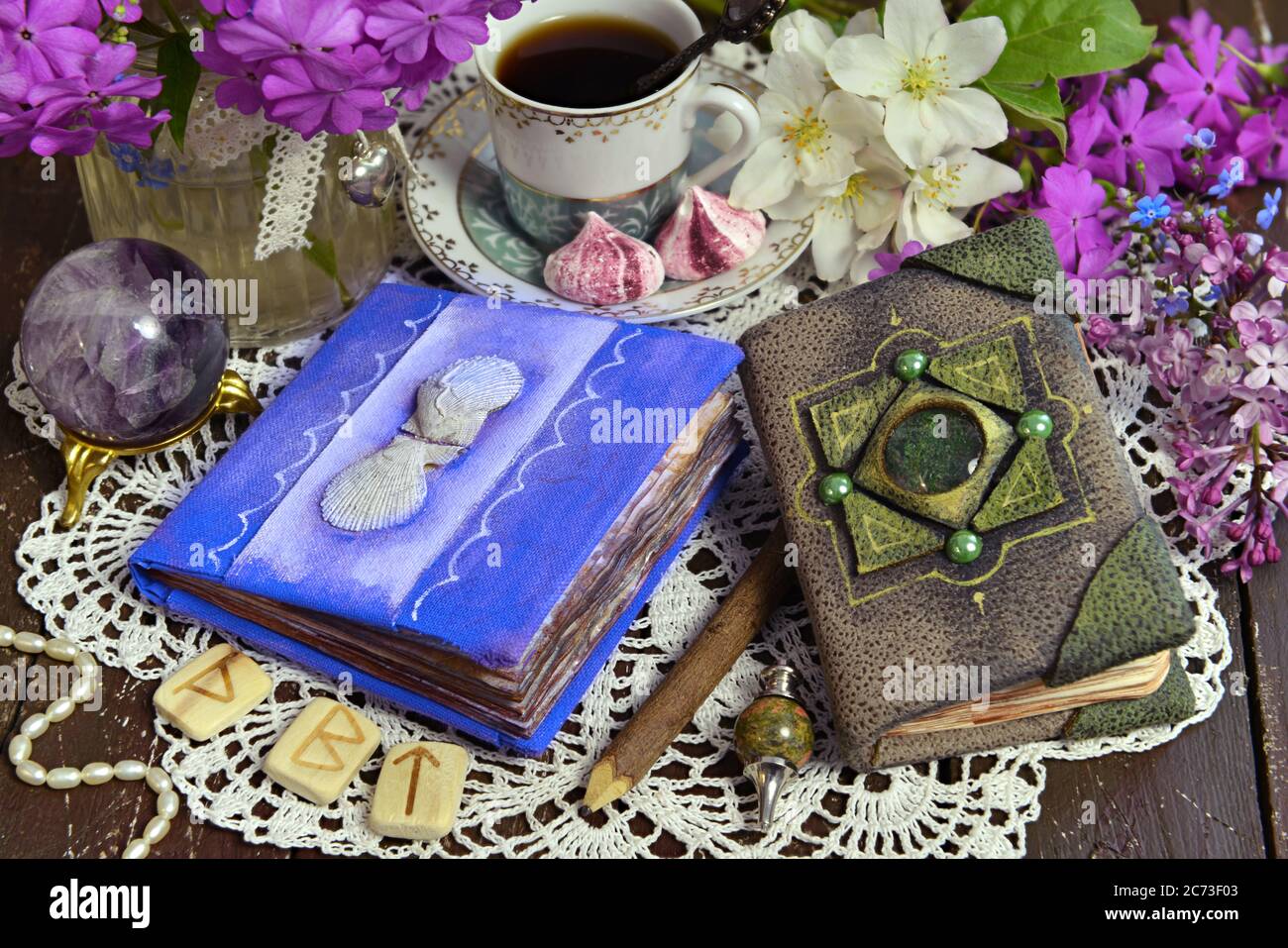 Decorated book and diary with cup of tea and flowers on green witch table.  Esoteric, gothic and occult background with magic objects, mystic and fairy  Stock Photo - Alamy