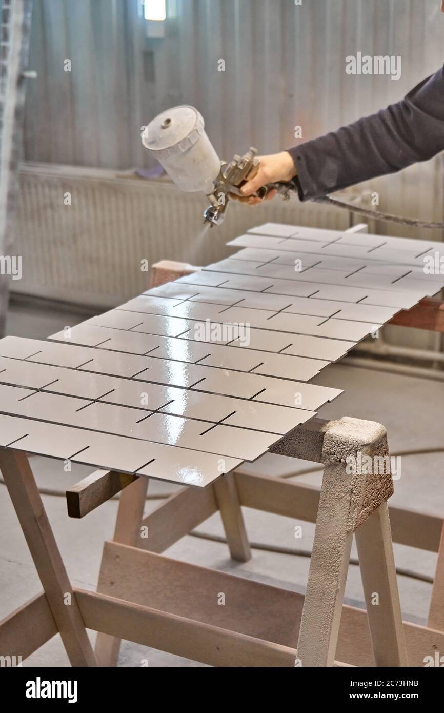 Painting furniture in a spray booth. Furniture manufacturing. Wooden