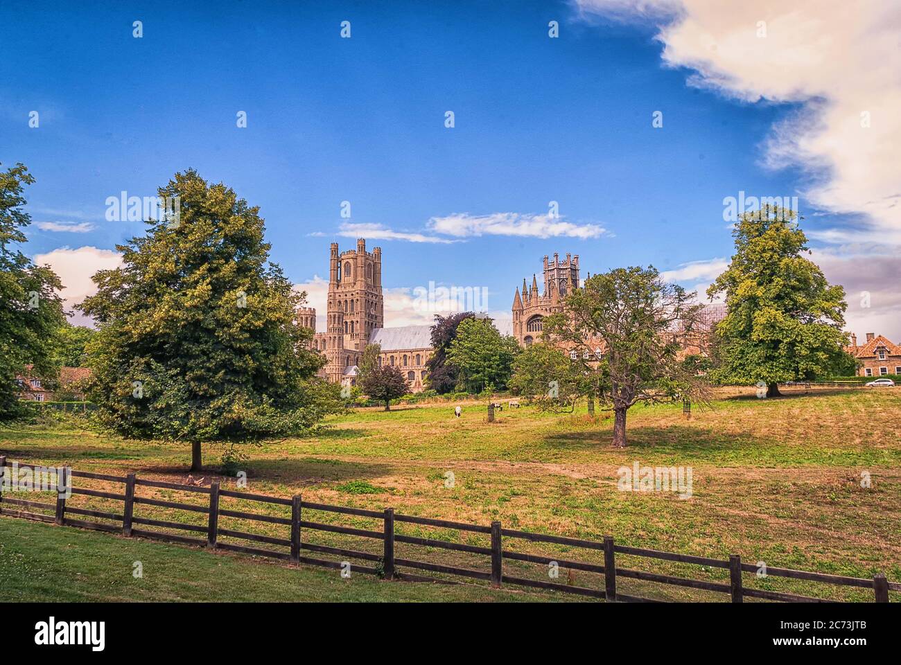 The west front (main entrance) of Ely Cathedral with scattered clouds ...