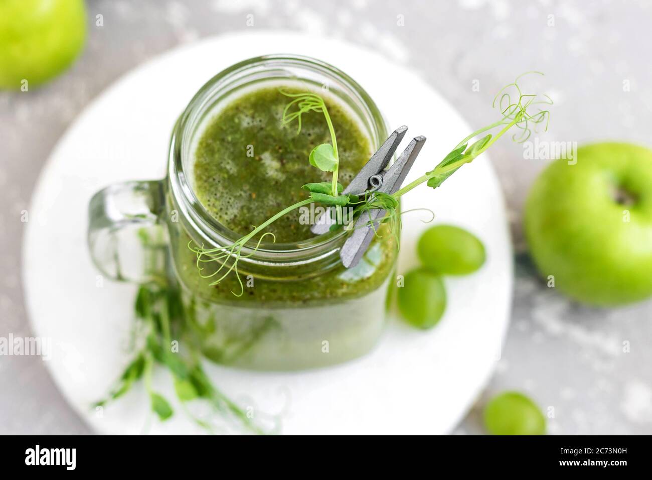 Green vitamin smoothie with shoots of young peas. Green smoothie made ...