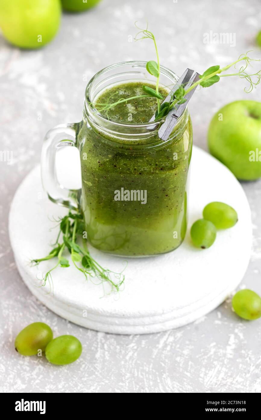 Green vitamin smoothie with shoots of young peas. Green smoothie made ...