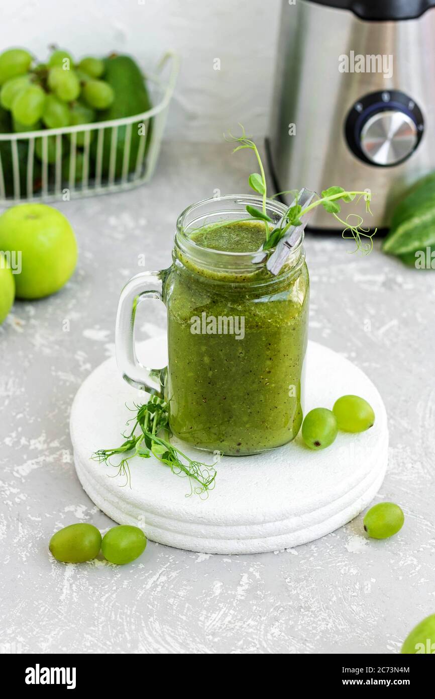 Green vitamin smoothie with shoots of young peas. Green smoothie made ...