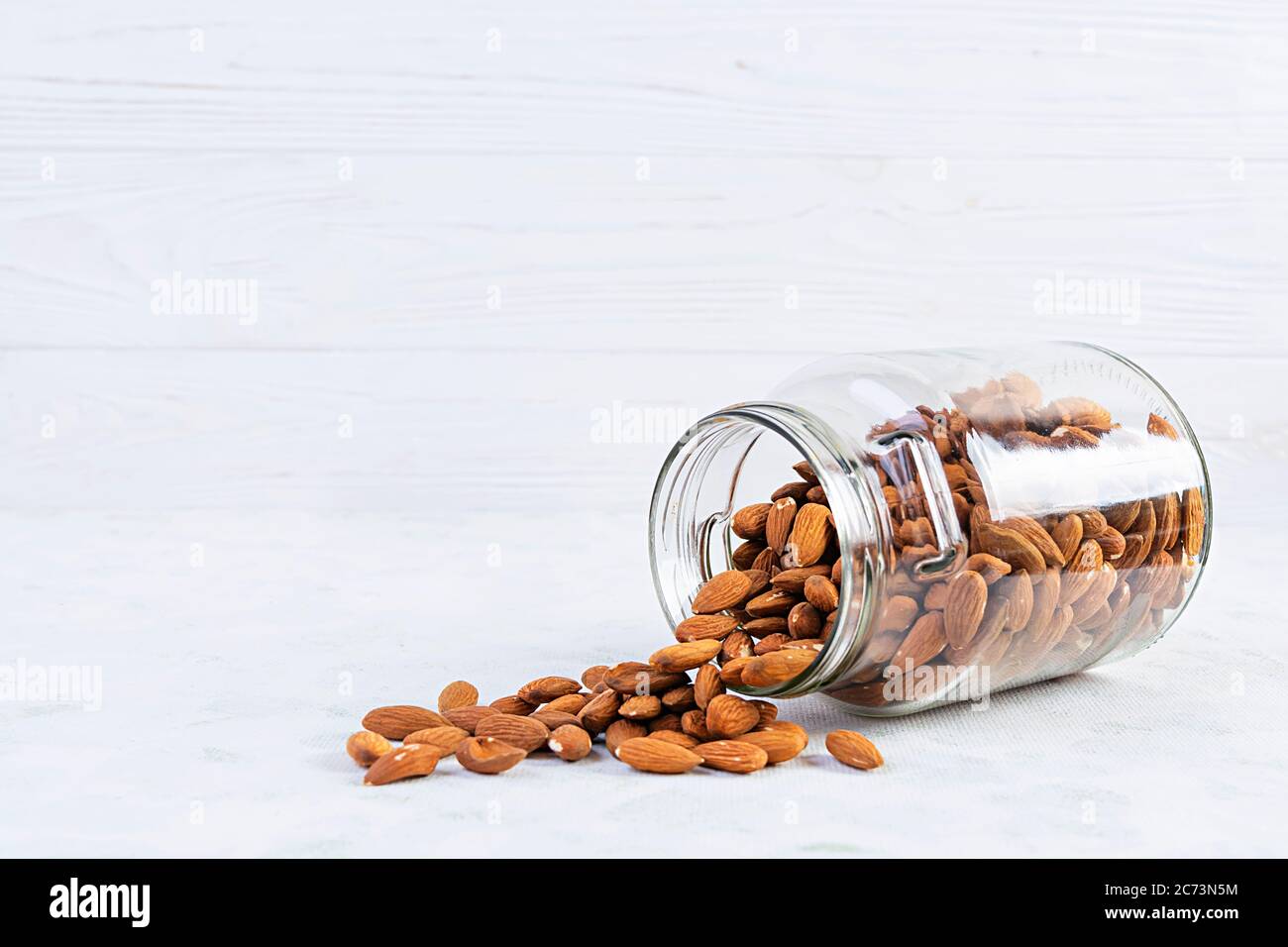 Almonds nuts in a jar. Set of nuts isolated on white background Stock