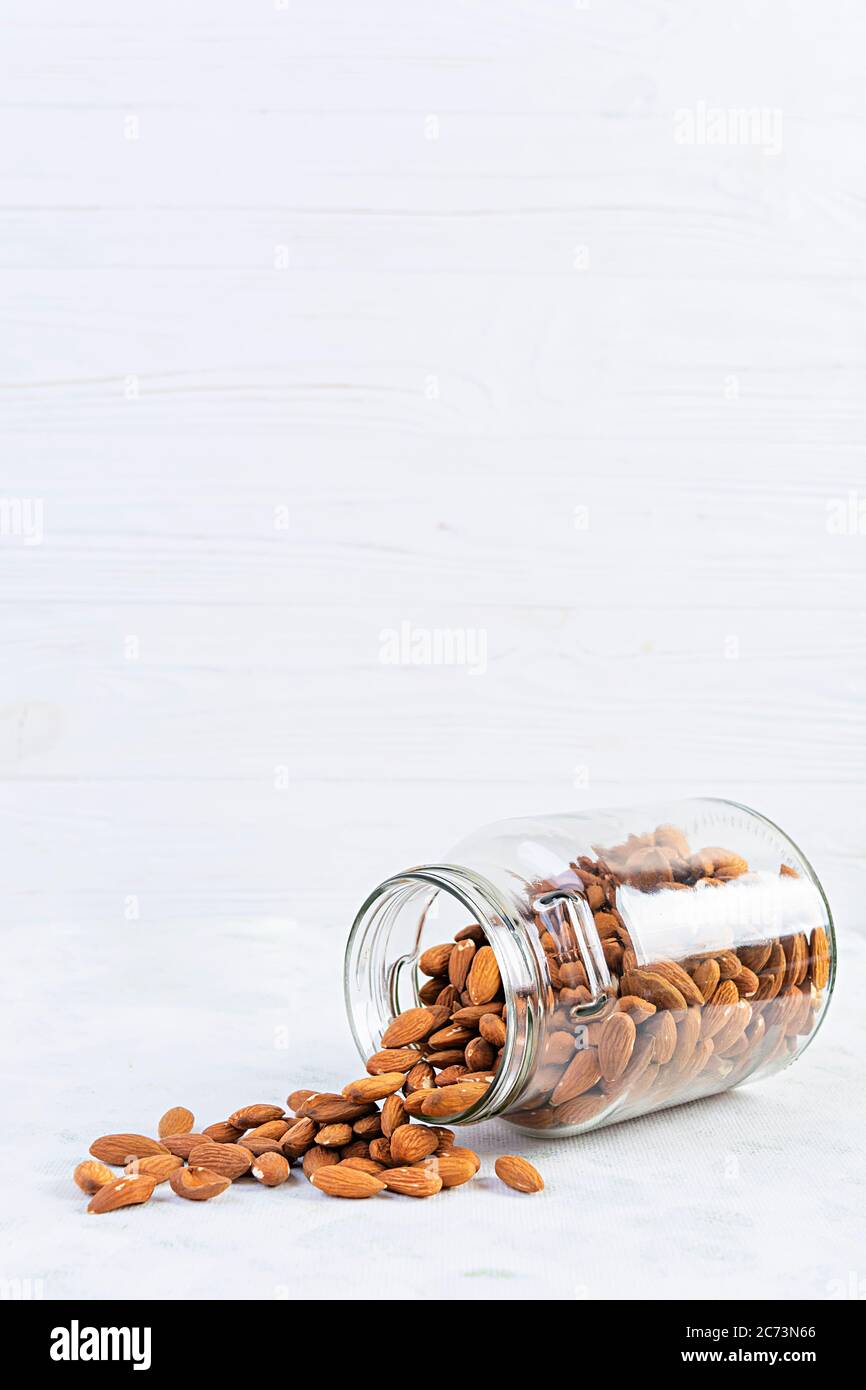 Almonds nuts in a jar. Set of nuts isolated on white background Stock