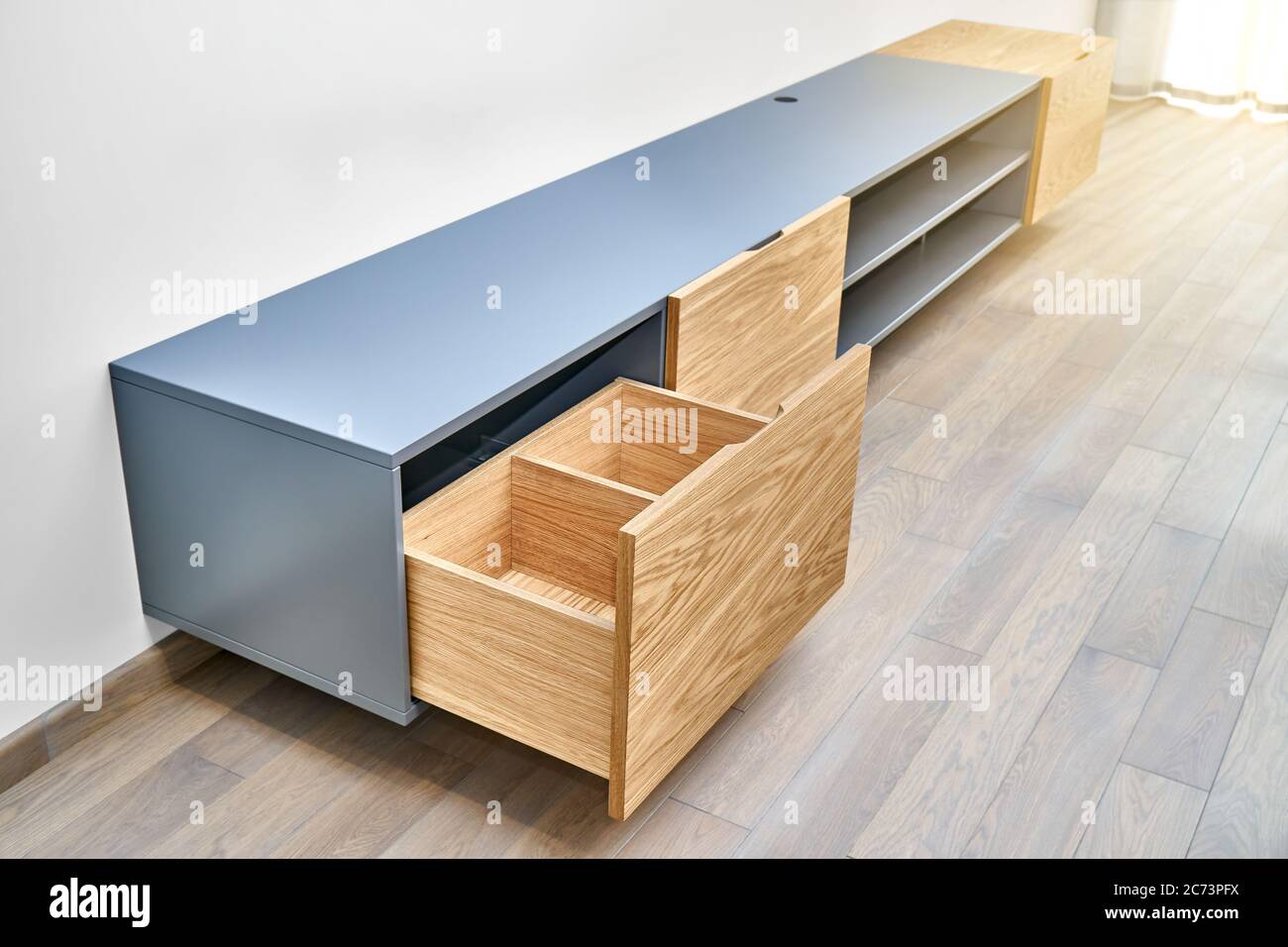 Contemporary floating media in living room. Wall mounted wooden