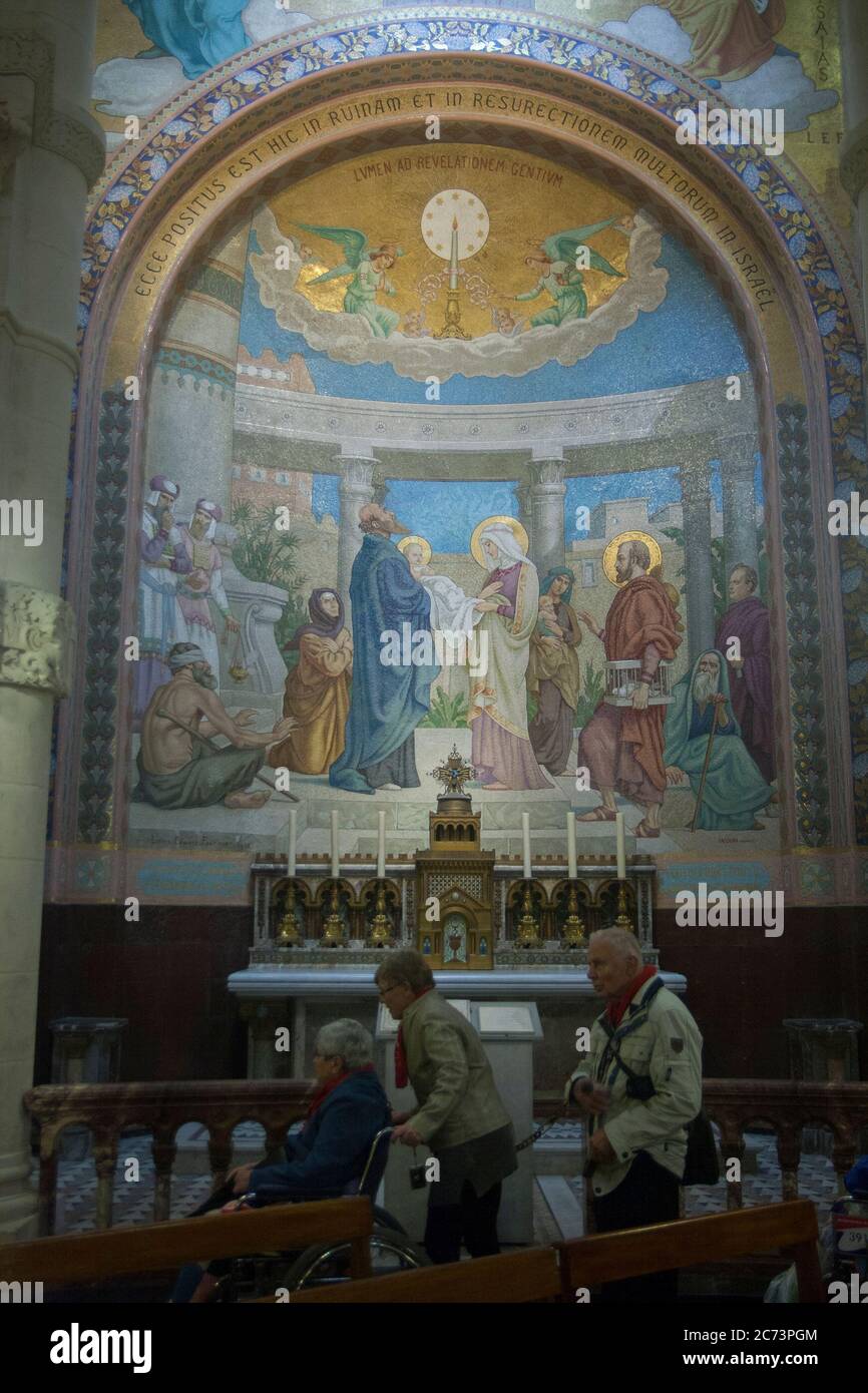 Apr 28. 2014 Lourdes France A light to enlighten the Gentiles. Monumental mosaic murals adorn the interior of Rosary Basilica. Stock Photo