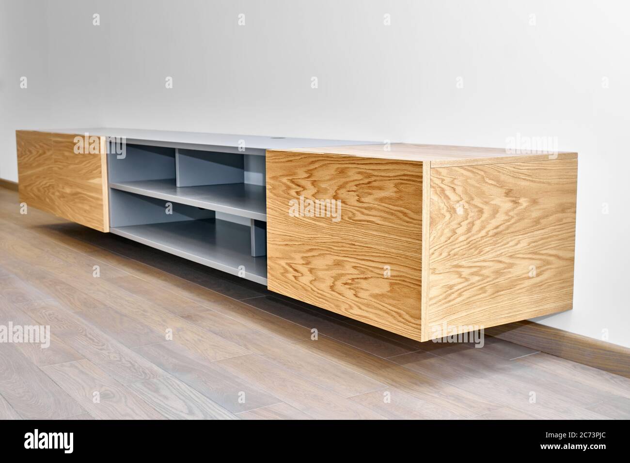 Contemporary floating media in living room. Wall mounted wooden