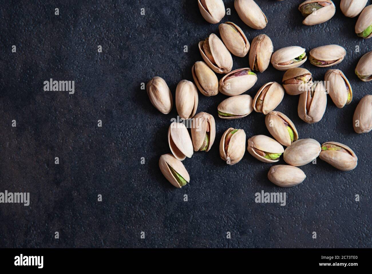 Roasted pistachios nuts on dark background. Healthy snack Stock Photo Alamy