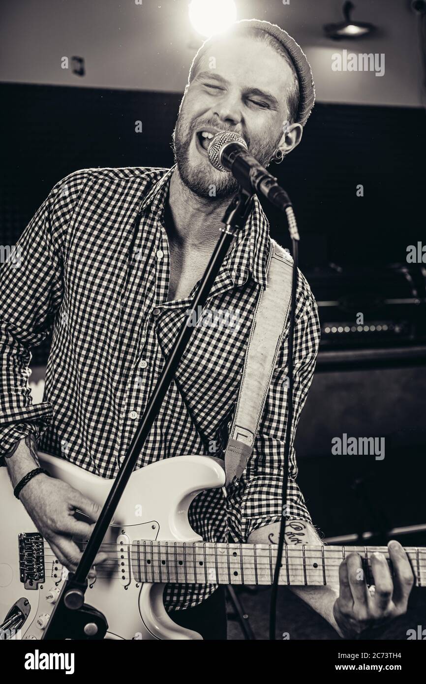 black and white photo of singing caucasian guitarist in recording ...