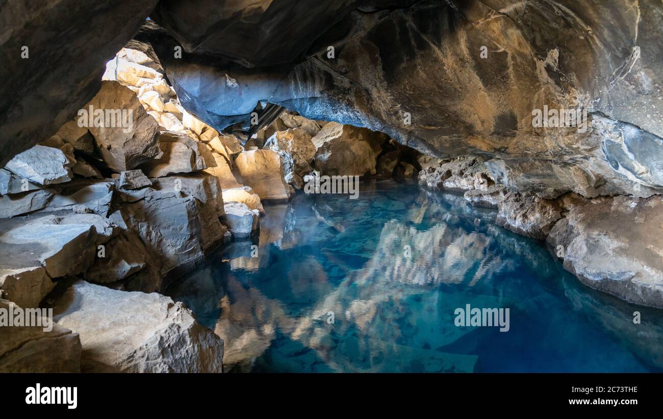Volcanic cave Grjotagja with a incredibly blue and hot thermal water near lake Myvatn in the northeastern Iceland Stock Photo