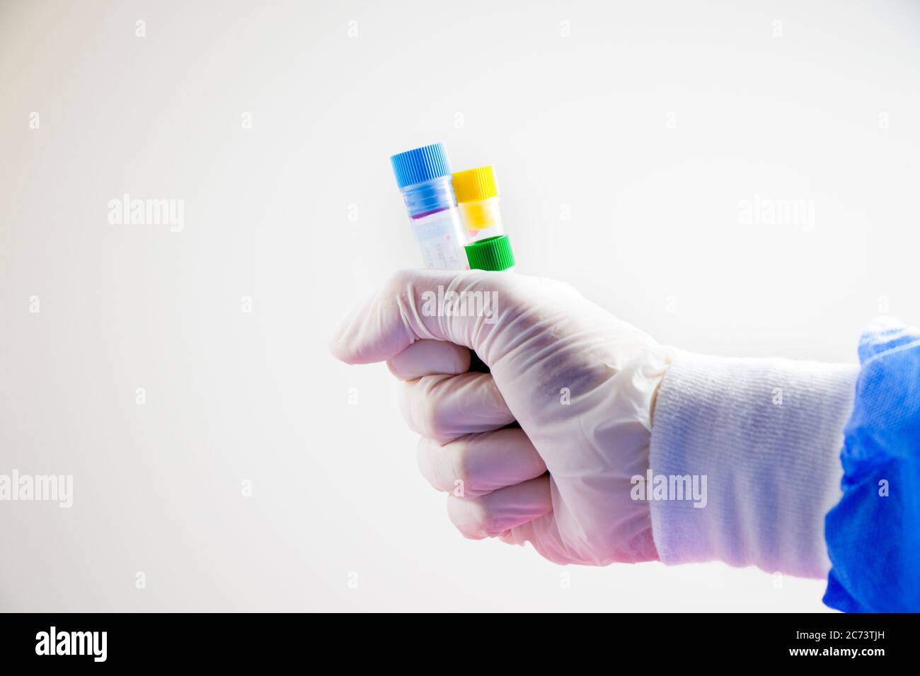 Blood test full tubes in hand, holding tubes,on the white background ...