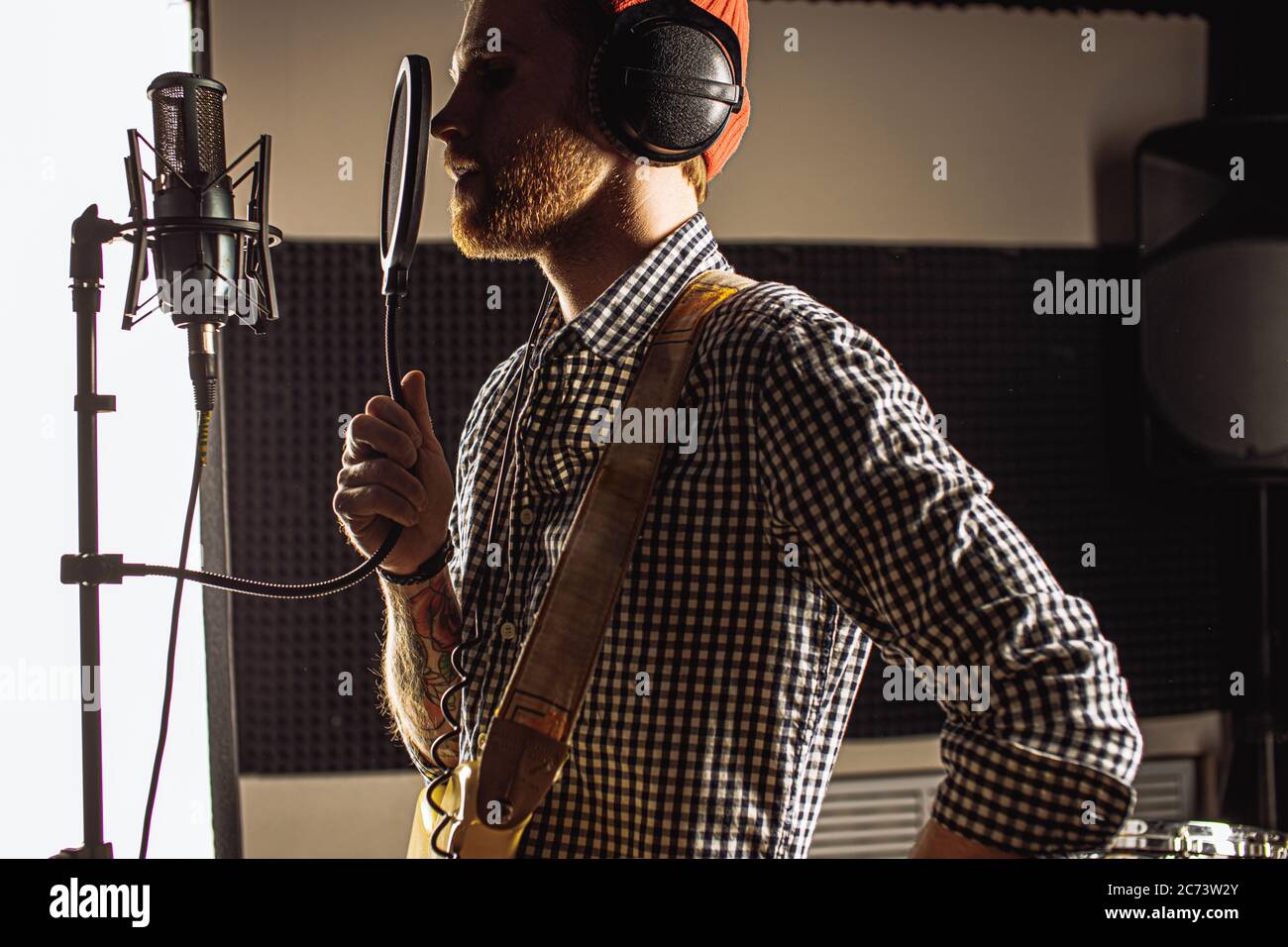 handsome caucasian guy in recording studio. young man professional