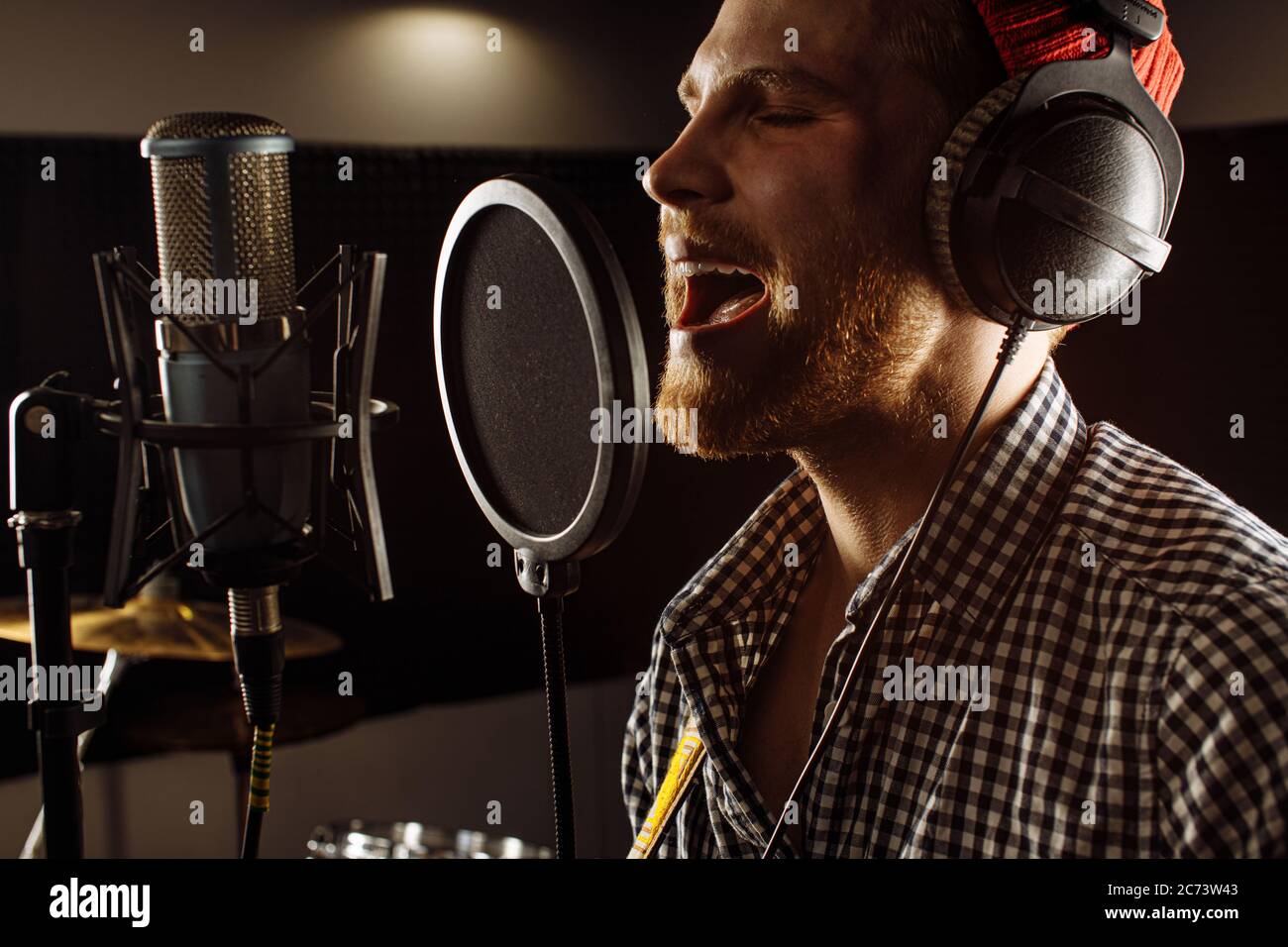 handsome caucasian guy in recording studio. young man professional