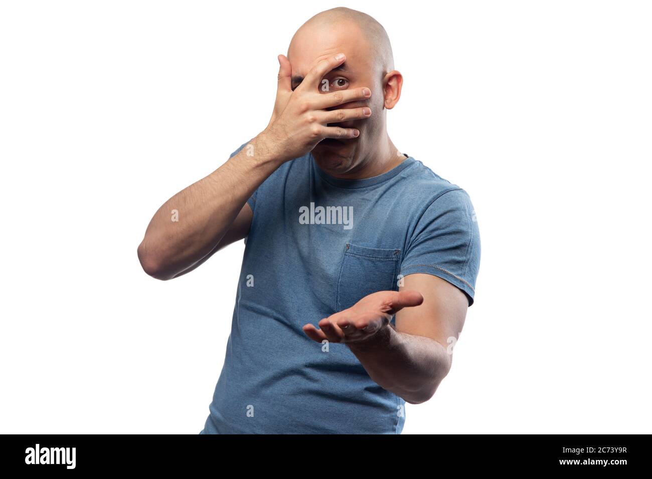 Bald puzzled man in tee shirt showing facepalm gesture Stock Photo