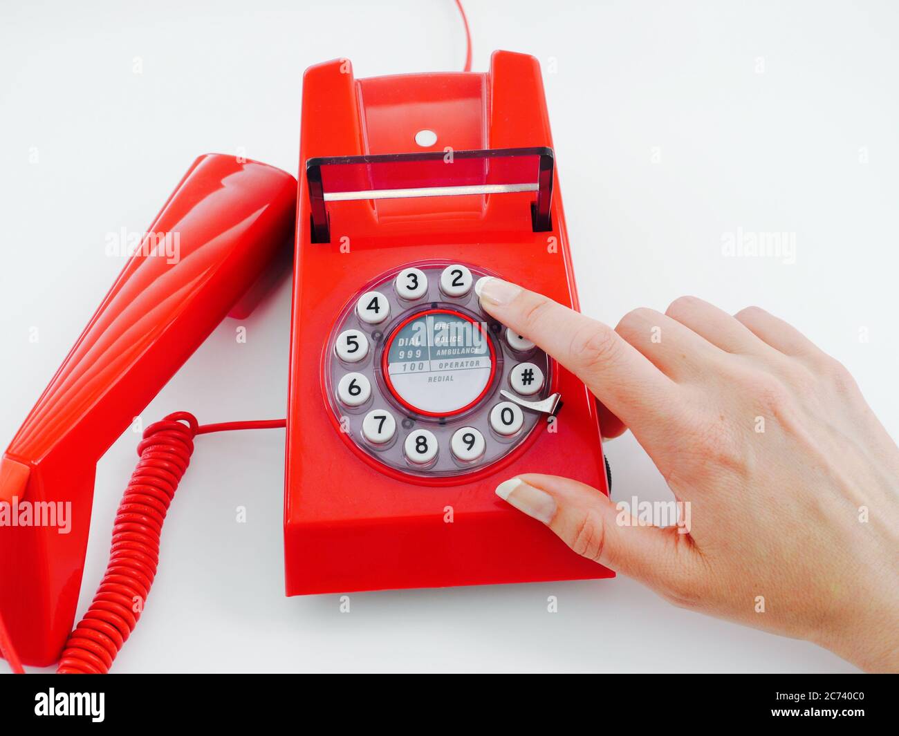 Female hand with natural nails makes a telephone call, dialling the number 1 Stock Photo