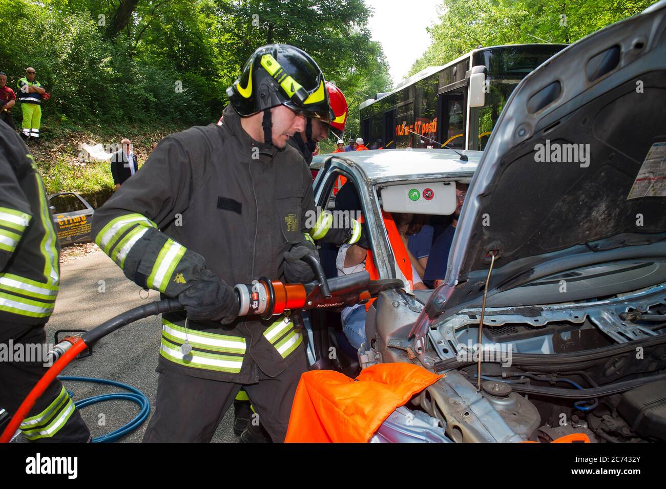 Europe, Italy, Lombardy, Monza. Emerlab Civil Defense Tutorial, Accident Simulation and Use of Equipment. Specifically, the sheet spreader and the hydraulic cutting-off machine to cut car parts and extract the injured person. Stock Photo