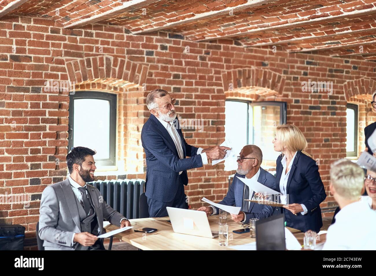 Group of businessmen wear stylish suits at table discuss project ...