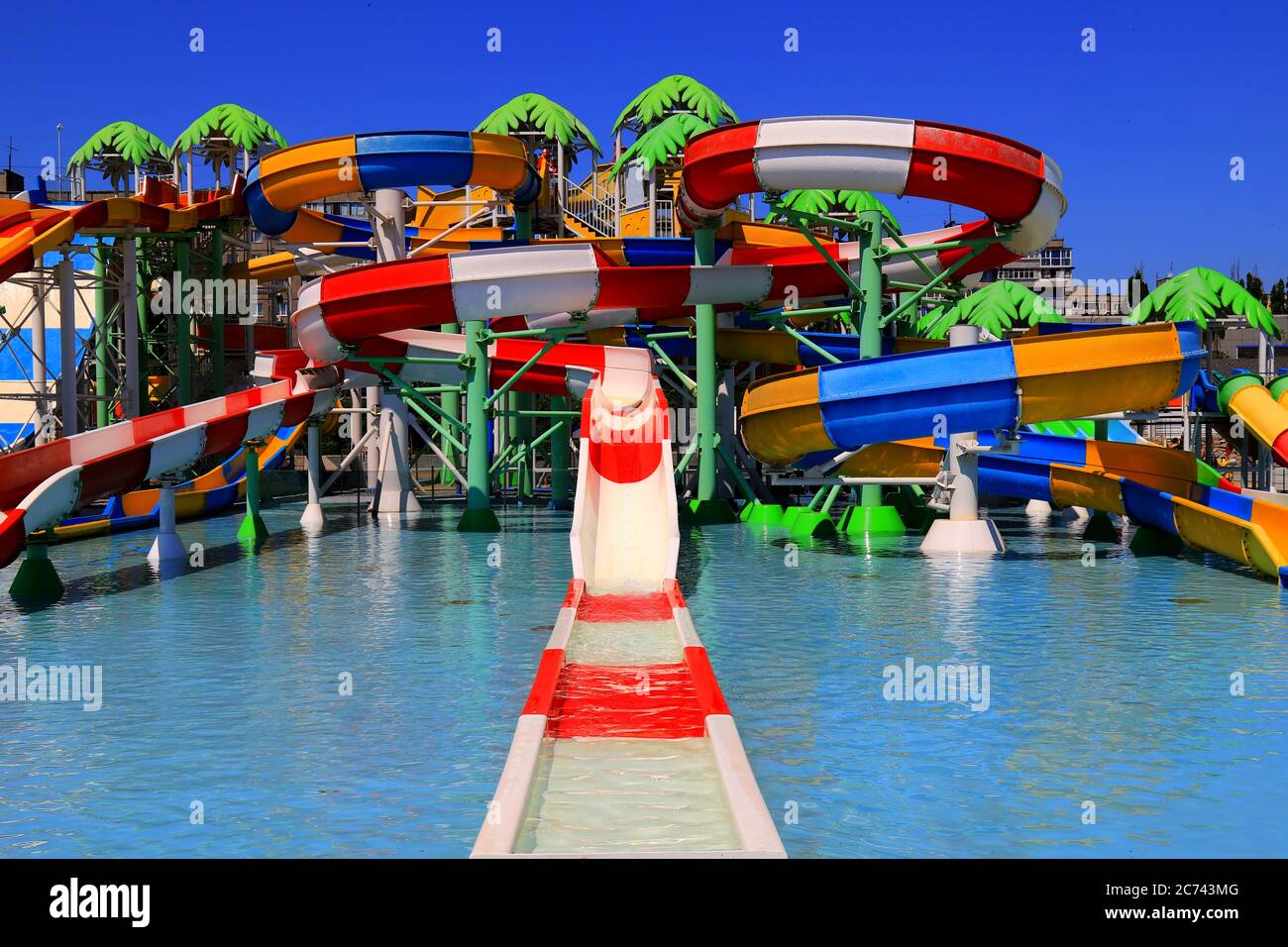 Colorful roller coasters in the picturesque water park. Resort in spring and summer, swimming and sports, active recreation. Dnepropetrovsk Stock Photo