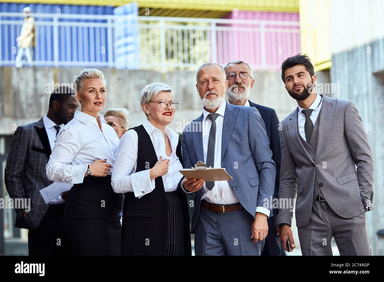 Group of businessmen wear stylish suits walking down the street Stock ...