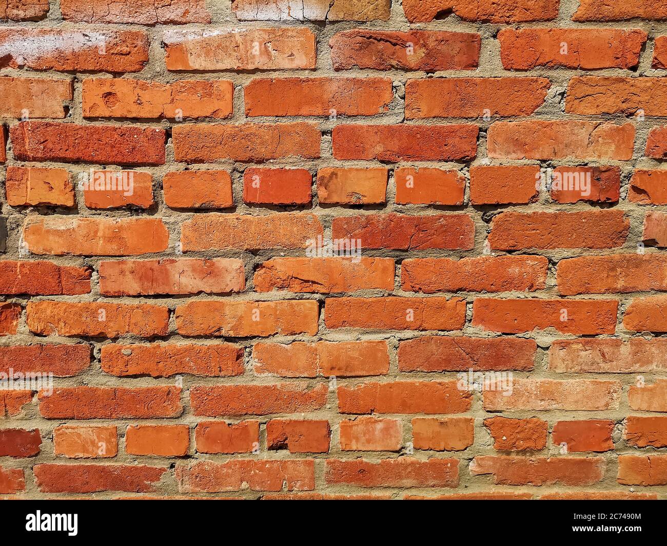 THE RED Weathered stained old brick wall. Stock Photo