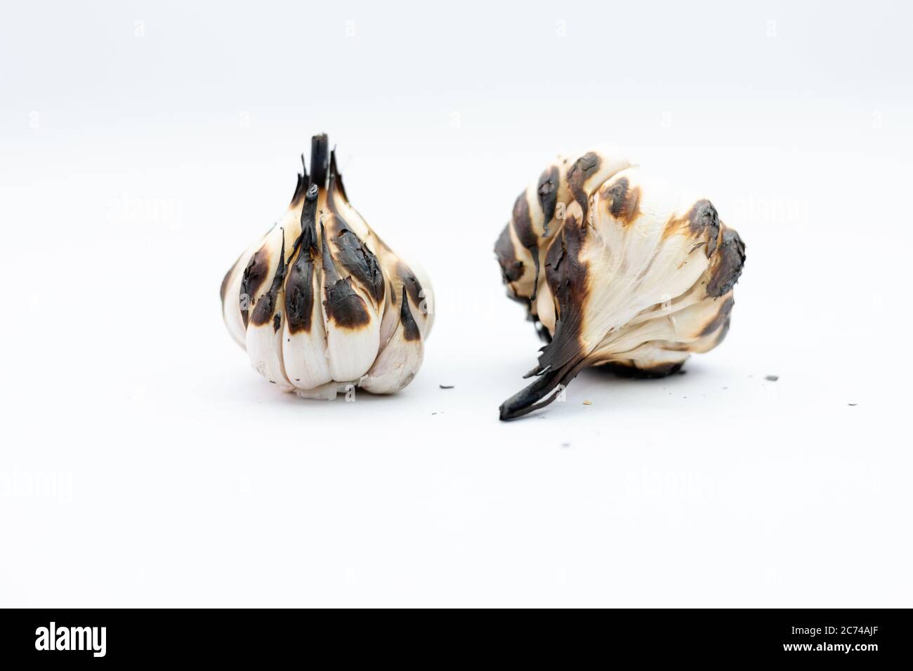 Roasted Garlic Cloves and Bulb in white background Stock Photo - Alamy