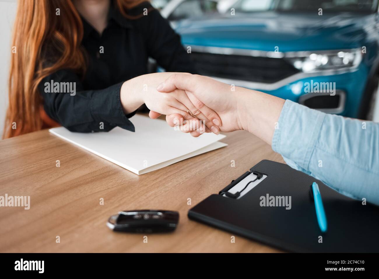 Successful deal at a car dealership Stock Photo Alamy