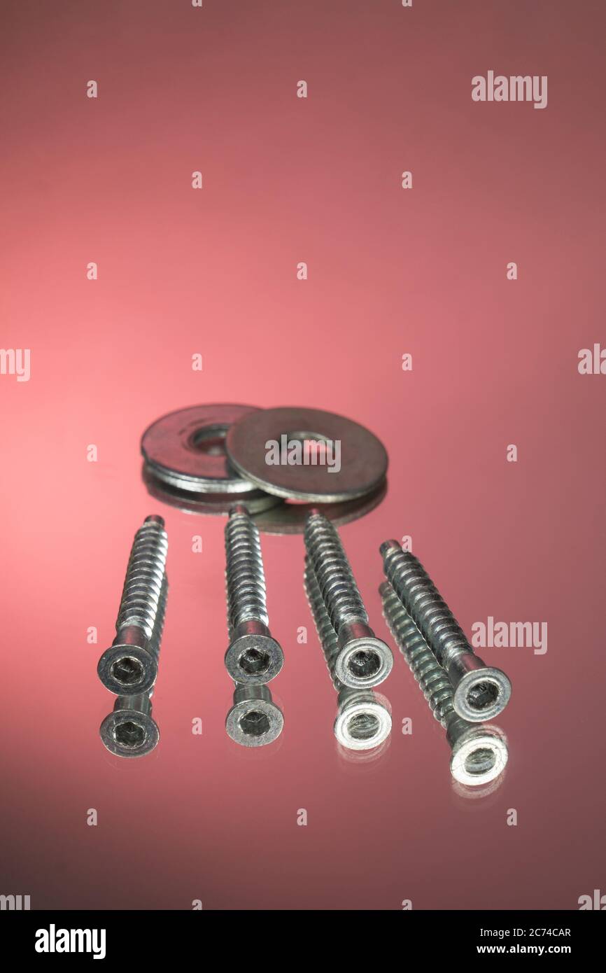 Countersunk wood screws on a red background Stock Photo Alamy