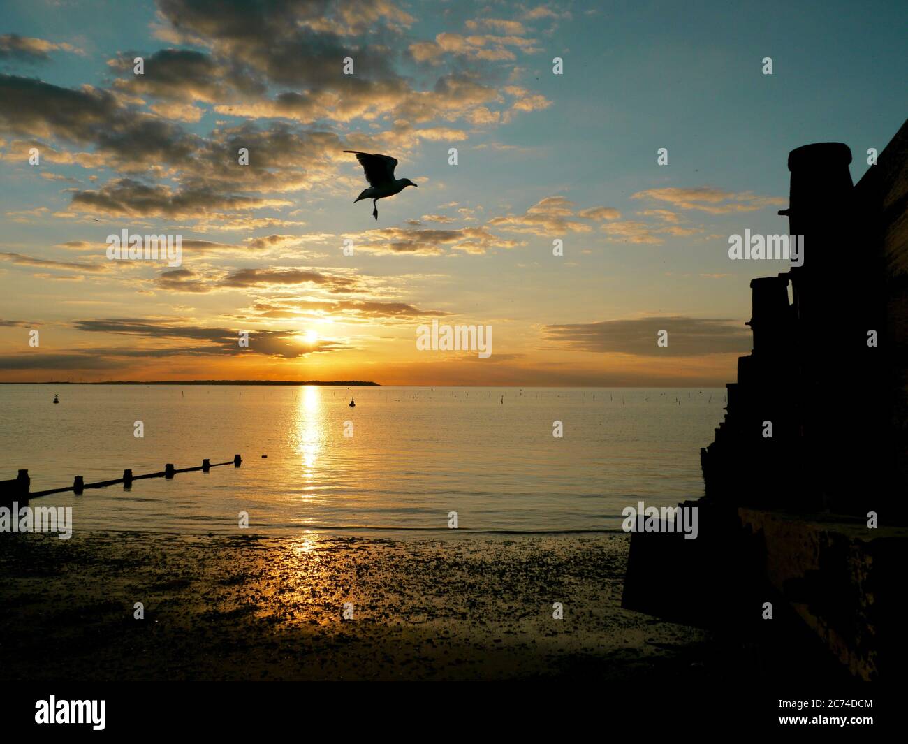 Sunset in the beautiful fishing village of Whitstable in Kent, looking towards the Isle of Sheppey. Stock Photo