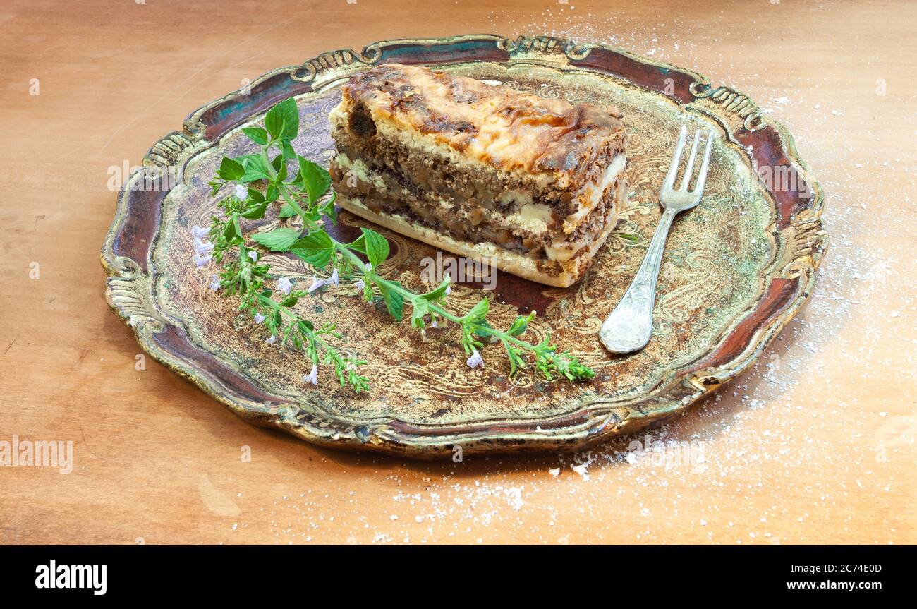 Typical Slovenian dessert with cream poppy seeds, in the studio on an elegant wooden tray. Stock Photo