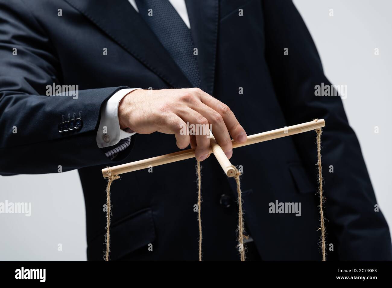smiling female puppeteer holding male marionette isolated on grey Stock  Photo - Alamy