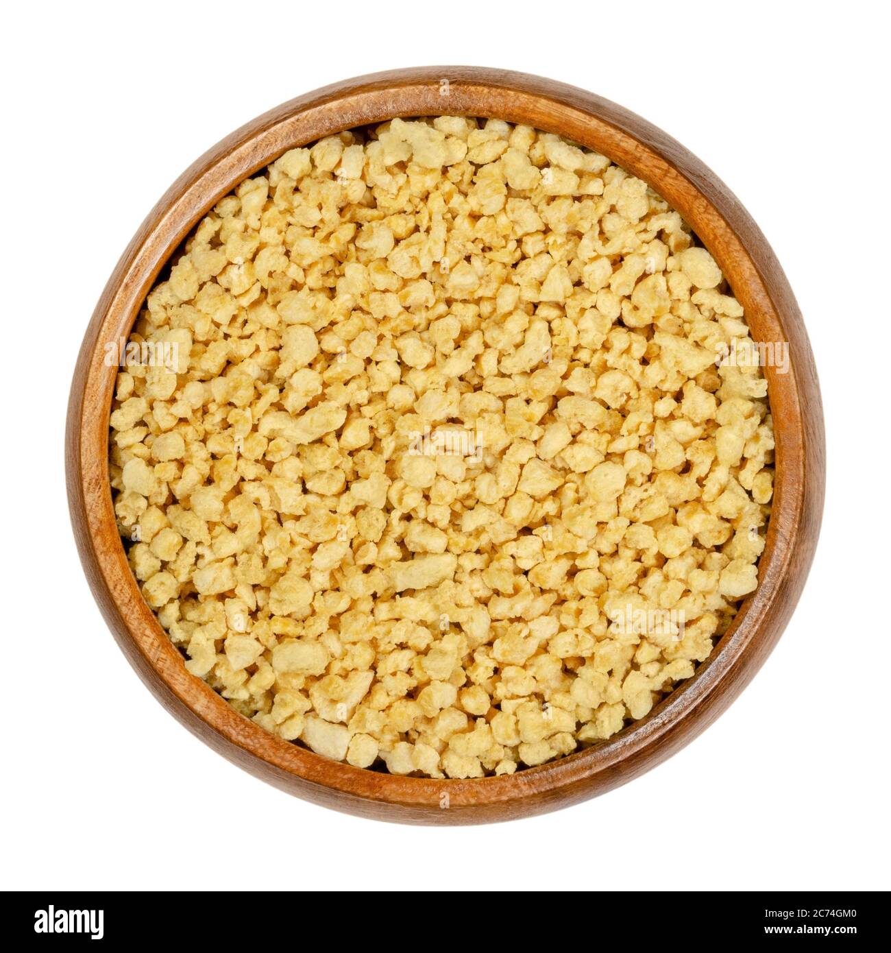 Soya granules in wooden bowl. Textured soy protein, also called soy meat. Defatted soy flour product, used as meat analogue or meat extender. Stock Photo