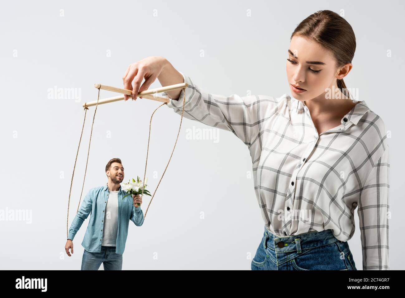 smiling female puppeteer holding male marionette isolated on grey Stock  Photo - Alamy