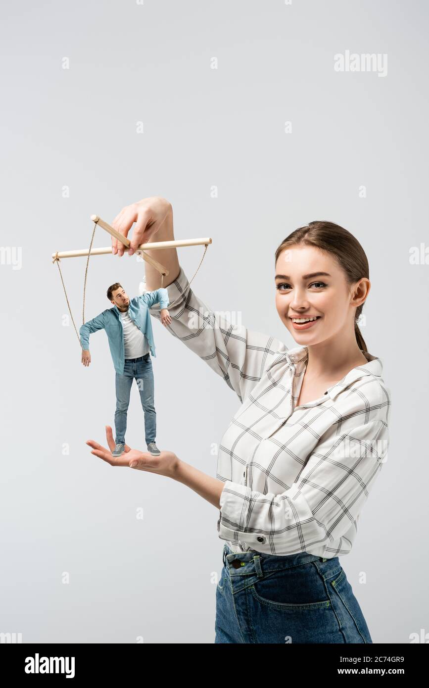 smiling female puppeteer holding male marionette isolated on grey Stock  Photo - Alamy