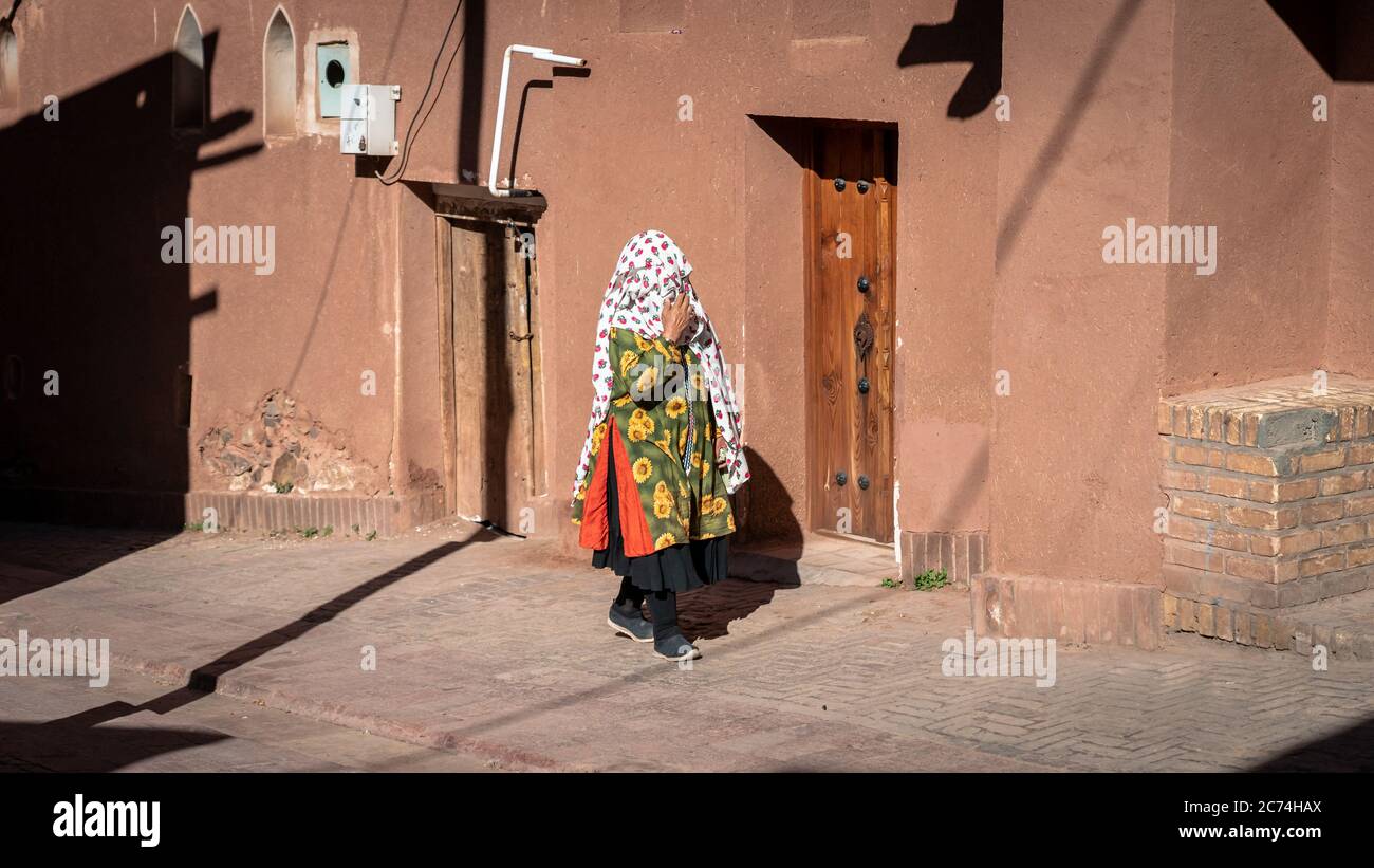 Abyaneh, Iran - May 2019: Unidentified woman with traditional Persian clothes walking in Abyahen Stock Photo