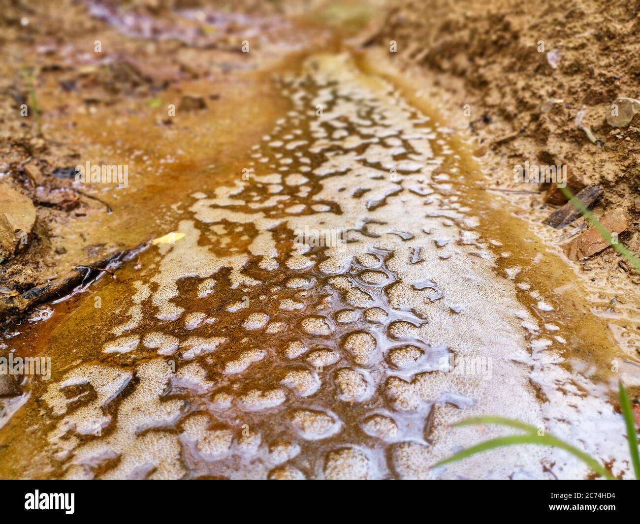 Mountain stream with oil stains flowing in Skhidnytsia urban-type settlement in Ukraine. Natural rich oil field. Stock Photo