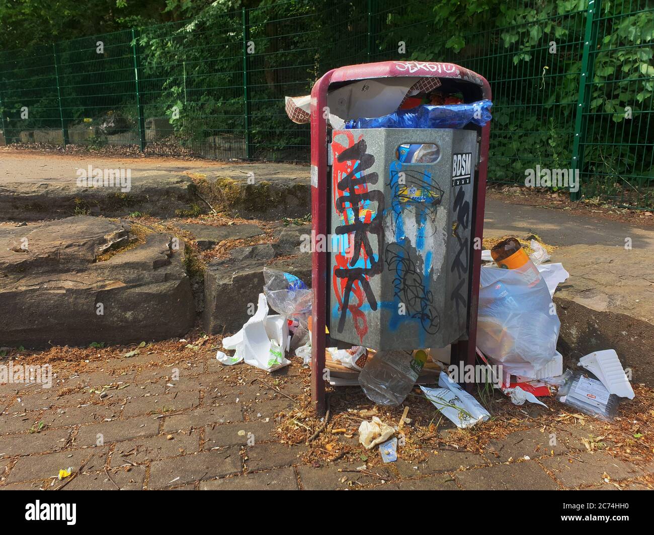 overfilled trash can on a parking lot, Germany Stock Photo Alamy