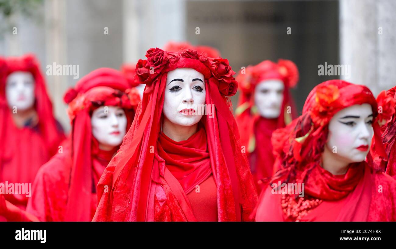 London, UK. 17th October 2019. Despite a city-wide ban on protests, member of Extinction Rebellion's Red Brigade walk slowly from Trafalgar Square to Stock Photo