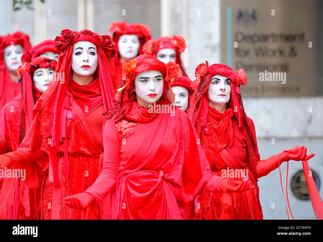 London, UK. 17th October 2019. Despite a city-wide ban on protests, member of Extinction Rebellion's Red Brigade walk slowly from Trafalgar Square to Stock Photo