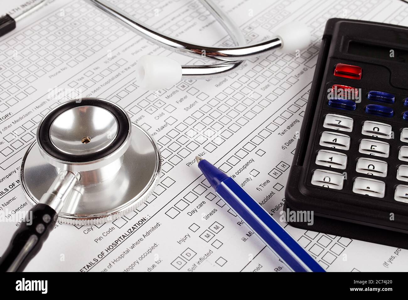Healthcare costing. Medical phonendoscope, calculator, pen Stock Photo