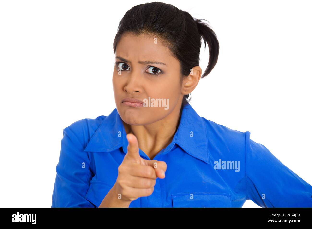 Portrait of young unhappy, serious woman pointing at someone finger isolated on white background Stock Photo